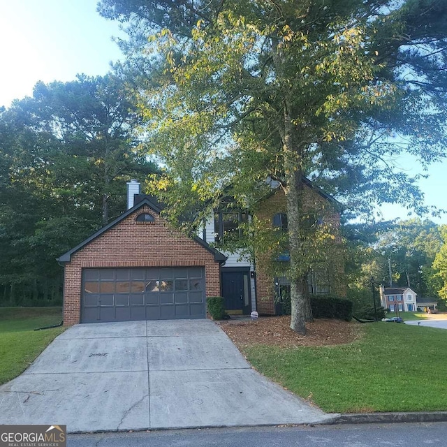 view of front of property featuring a garage and a front lawn