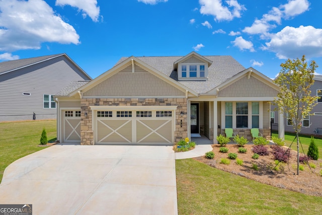 craftsman house featuring a garage, a front lawn, and a porch