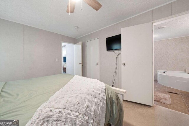 bedroom featuring ceiling fan and a textured ceiling