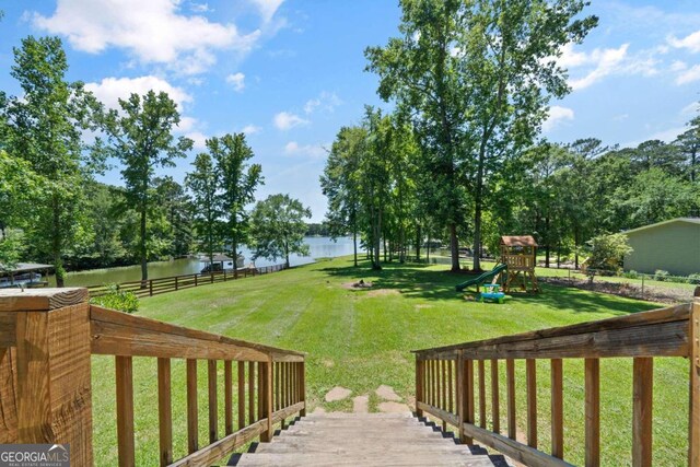 view of yard featuring a playground and a water view