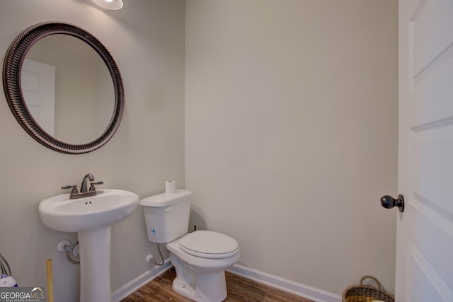 bathroom featuring toilet and wood-type flooring