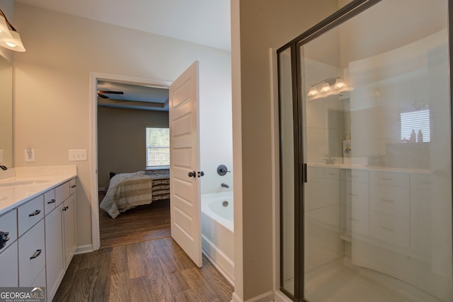 bathroom with vanity, separate shower and tub, and hardwood / wood-style floors