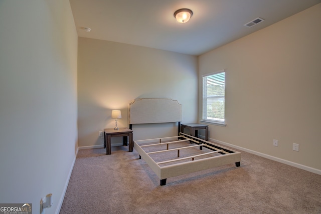 bedroom featuring light colored carpet