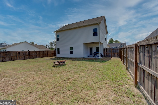 rear view of house featuring a lawn and a patio