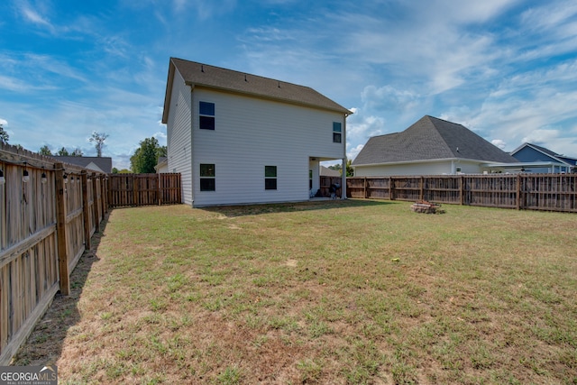 back of property with a lawn