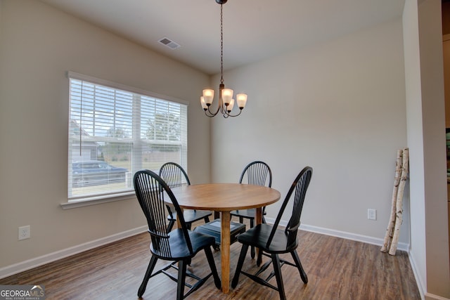 dining room with a chandelier and hardwood / wood-style floors