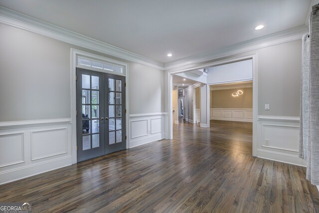 unfurnished room with crown molding, dark wood-type flooring, and french doors