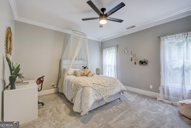 carpeted bedroom featuring crown molding and ceiling fan