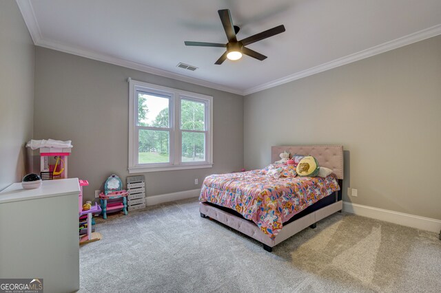 bedroom with crown molding, ceiling fan, and carpet flooring