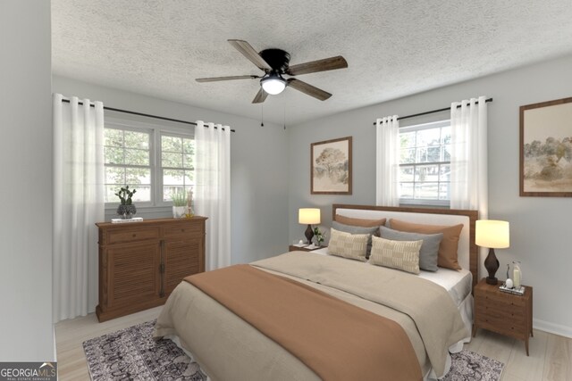 bedroom with ceiling fan, light hardwood / wood-style flooring, and a textured ceiling