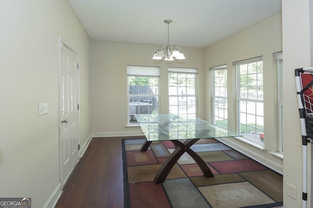 dining room featuring dark wood-type flooring and a notable chandelier