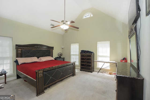 bedroom featuring multiple windows, light colored carpet, and ceiling fan