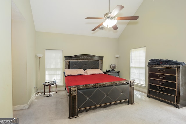 carpeted bedroom featuring high vaulted ceiling and ceiling fan