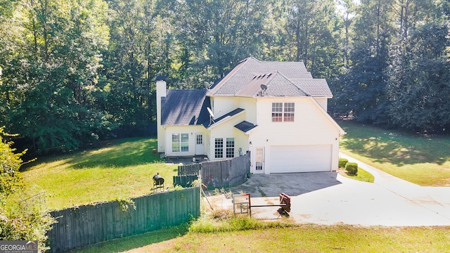 view of front of home with a garage and a front yard