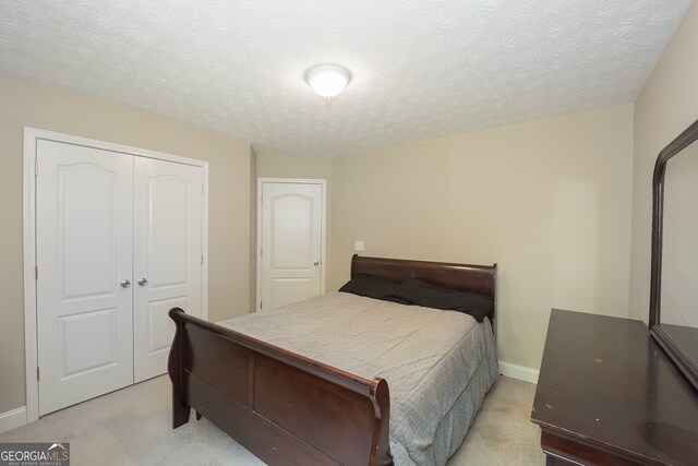 carpeted bedroom with a textured ceiling