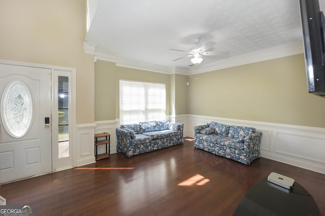 entrance foyer with a wealth of natural light, crown molding, ceiling fan, and dark hardwood / wood-style flooring