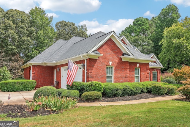 view of front of home featuring a garage and a front yard