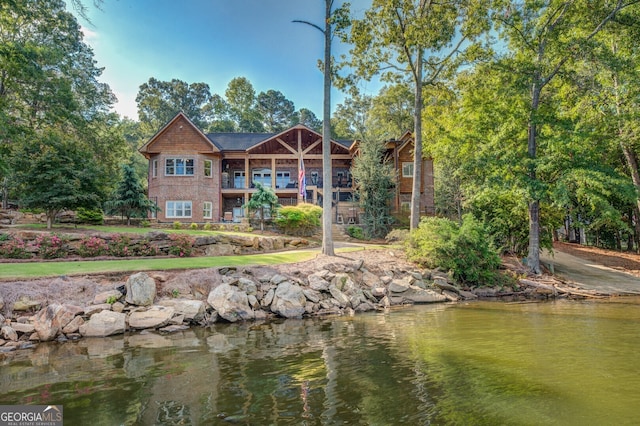 rear view of property with a water view