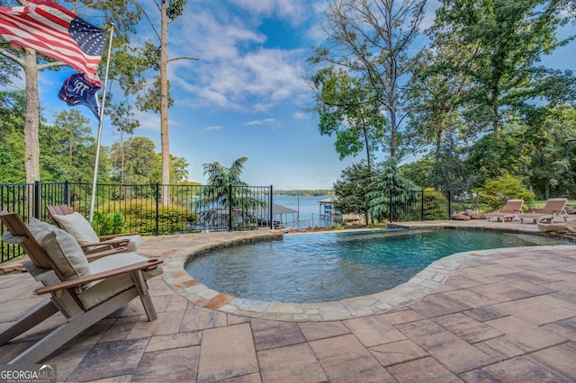 view of pool featuring a patio and a water view