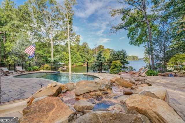 view of swimming pool with a water view, pool water feature, and a patio