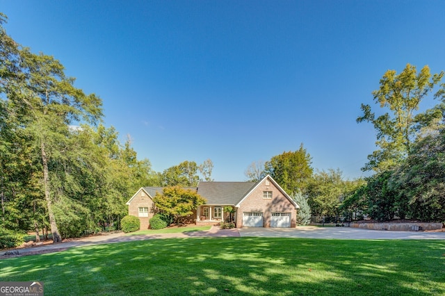 view of front facade with a front yard and a garage