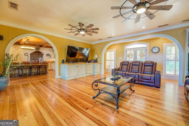 living room featuring ornamental molding, hardwood / wood-style flooring, and ceiling fan