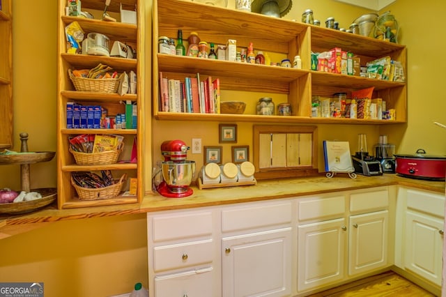 kitchen featuring white cabinetry and light hardwood / wood-style floors