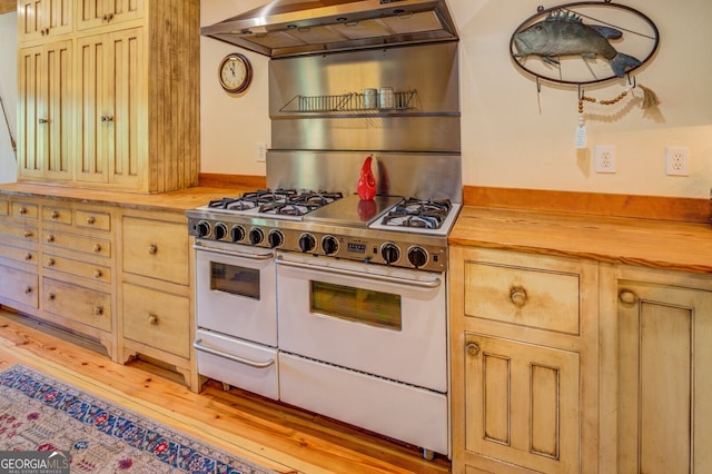 kitchen featuring ventilation hood, wood counters, double oven range, and light hardwood / wood-style floors