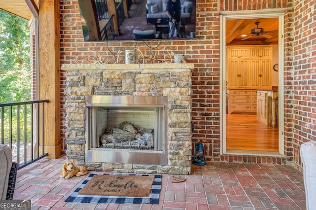 interior details with ceiling fan and a fireplace