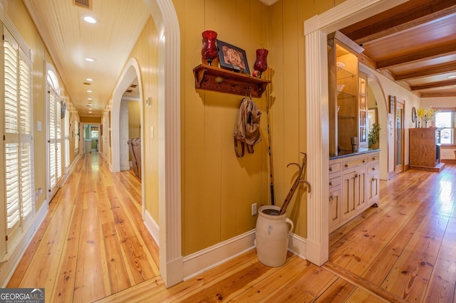 hall featuring wood-type flooring and beamed ceiling