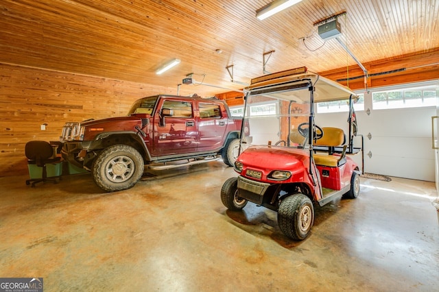 garage featuring wood walls and a garage door opener