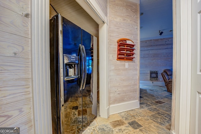 bathroom with wooden walls and heating unit