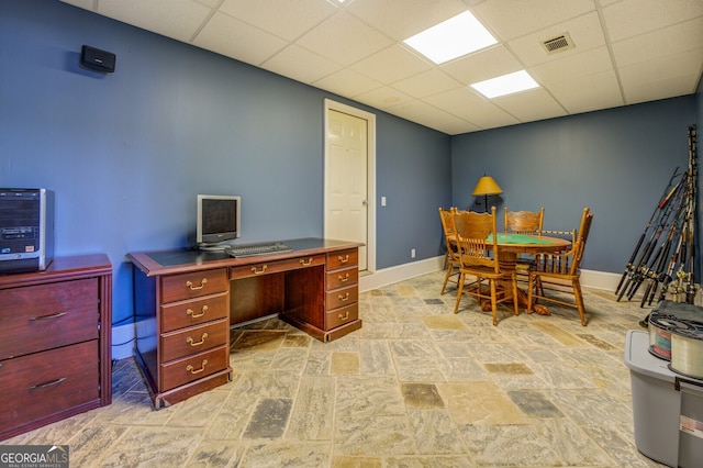 office area with a paneled ceiling