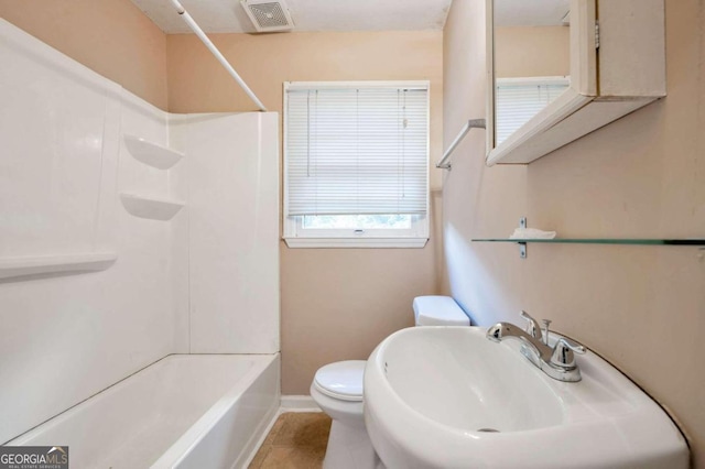 full bathroom with tile patterned flooring, toilet, shower / bathing tub combination, and sink