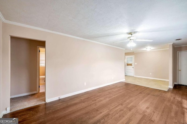 spare room with a textured ceiling, crown molding, ceiling fan, and hardwood / wood-style floors