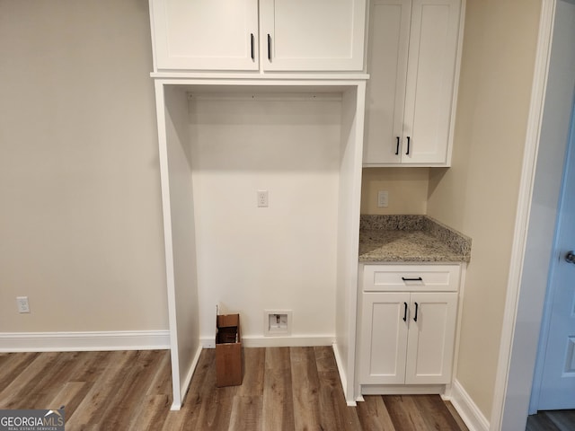 laundry room with washer hookup, dark wood-type flooring, and cabinets