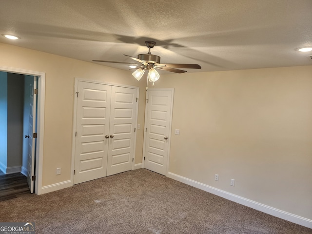 unfurnished bedroom with a textured ceiling, ceiling fan, and carpet floors