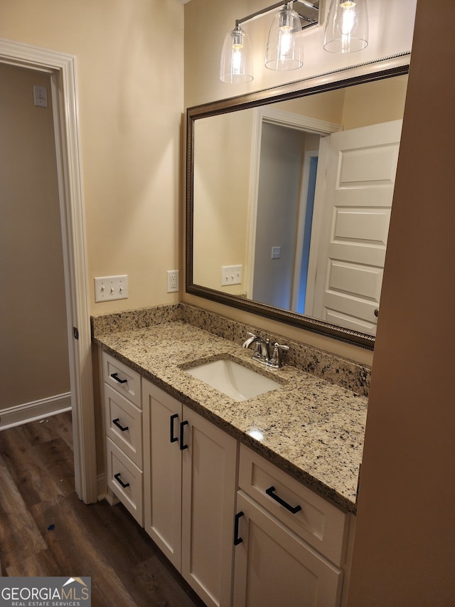 bathroom featuring hardwood / wood-style flooring and vanity