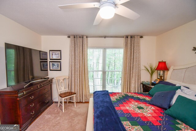 bedroom featuring light colored carpet and ceiling fan