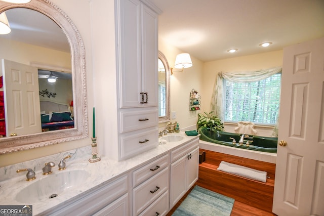 bathroom with vanity, hardwood / wood-style floors, and ceiling fan