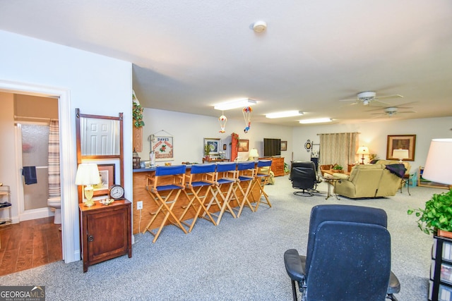 interior space with ceiling fan