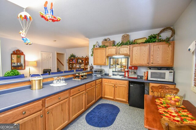 kitchen with dishwasher, pendant lighting, and sink