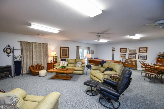 living room featuring ceiling fan and carpet floors