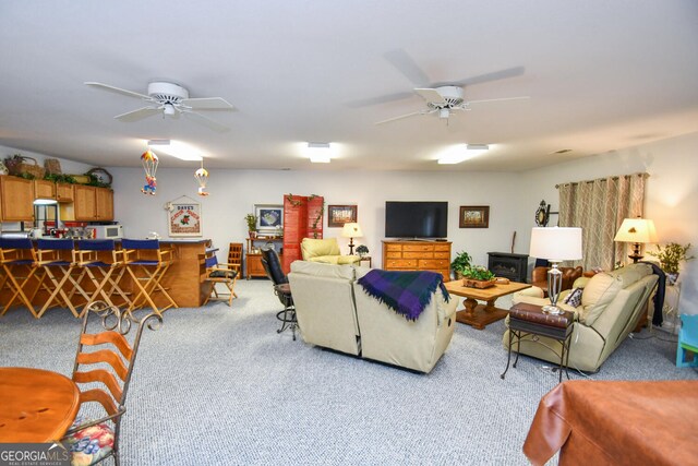 carpeted living room with ceiling fan