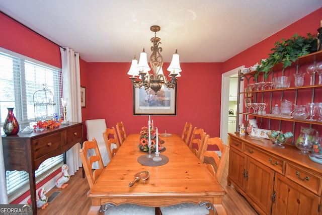 dining room featuring hardwood / wood-style flooring and a notable chandelier