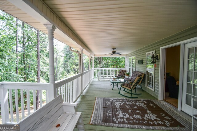 wooden deck featuring ceiling fan and a porch