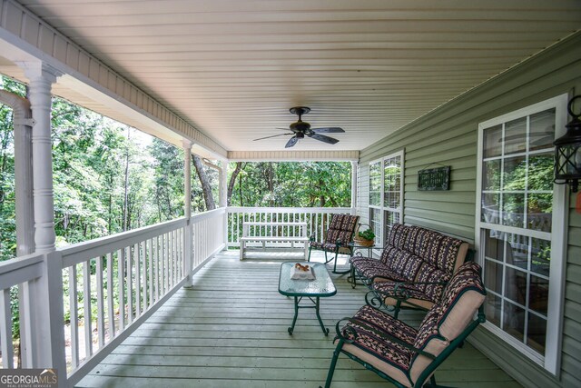 wooden deck featuring ceiling fan and covered porch