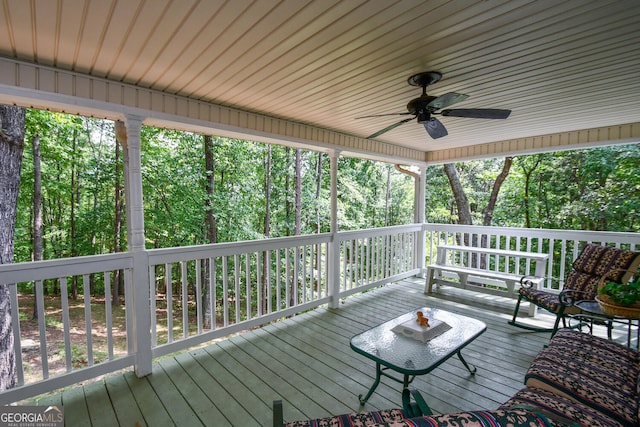 wooden deck featuring ceiling fan