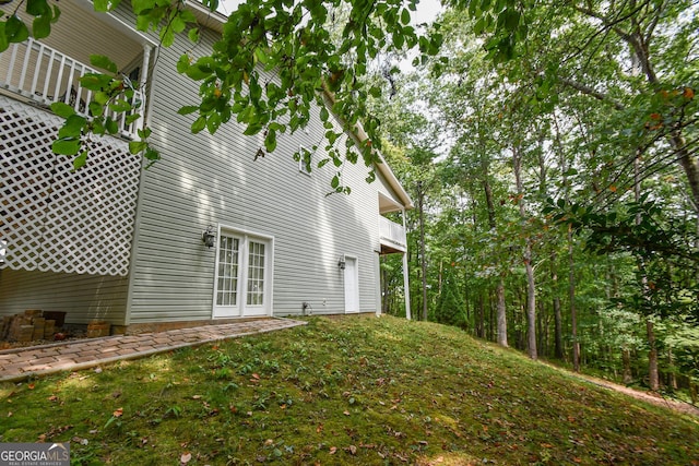 view of home's exterior featuring french doors and a lawn