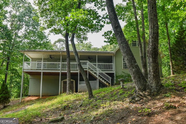 rear view of house featuring ceiling fan